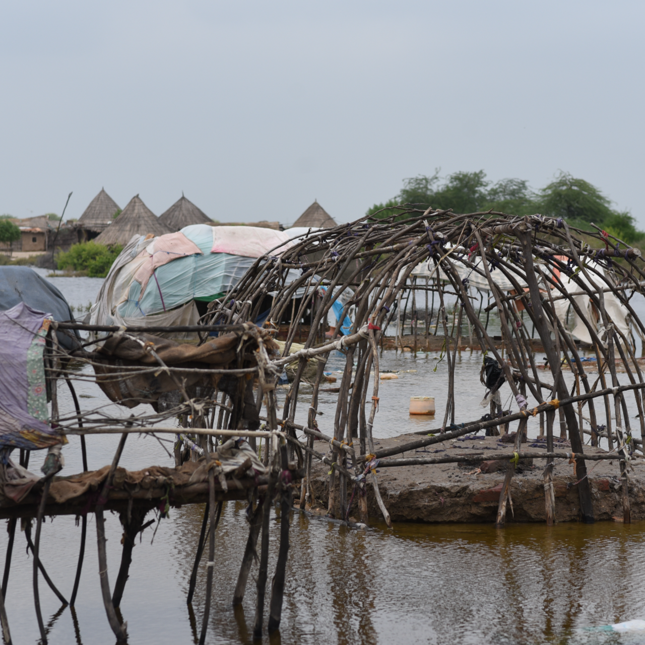 Destroyed homes were left with only wooden support beams standing. The rest of the homes were washed away by floods.